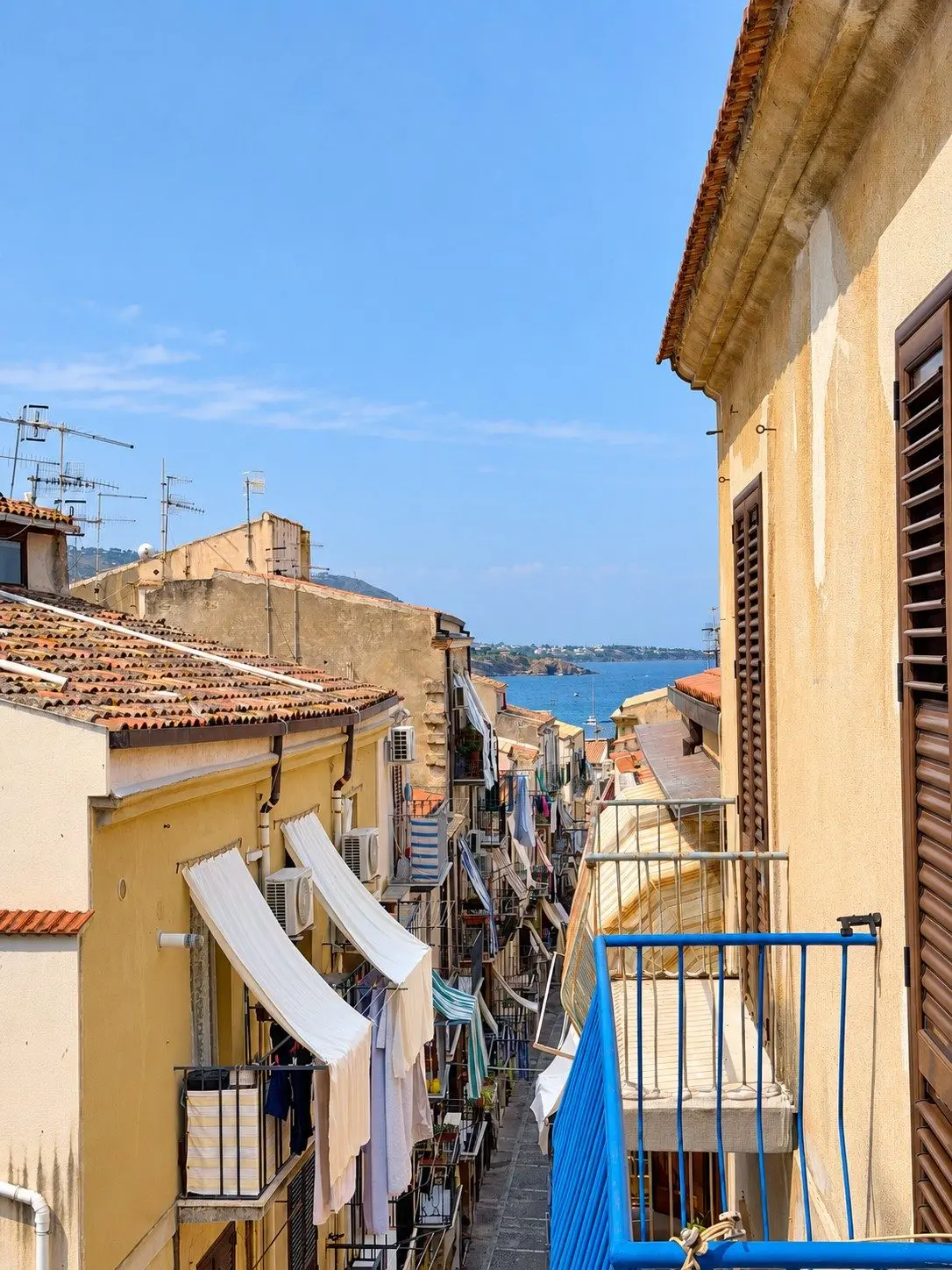 The sea and old-town rooftops from the balcony of Casa del Duomo